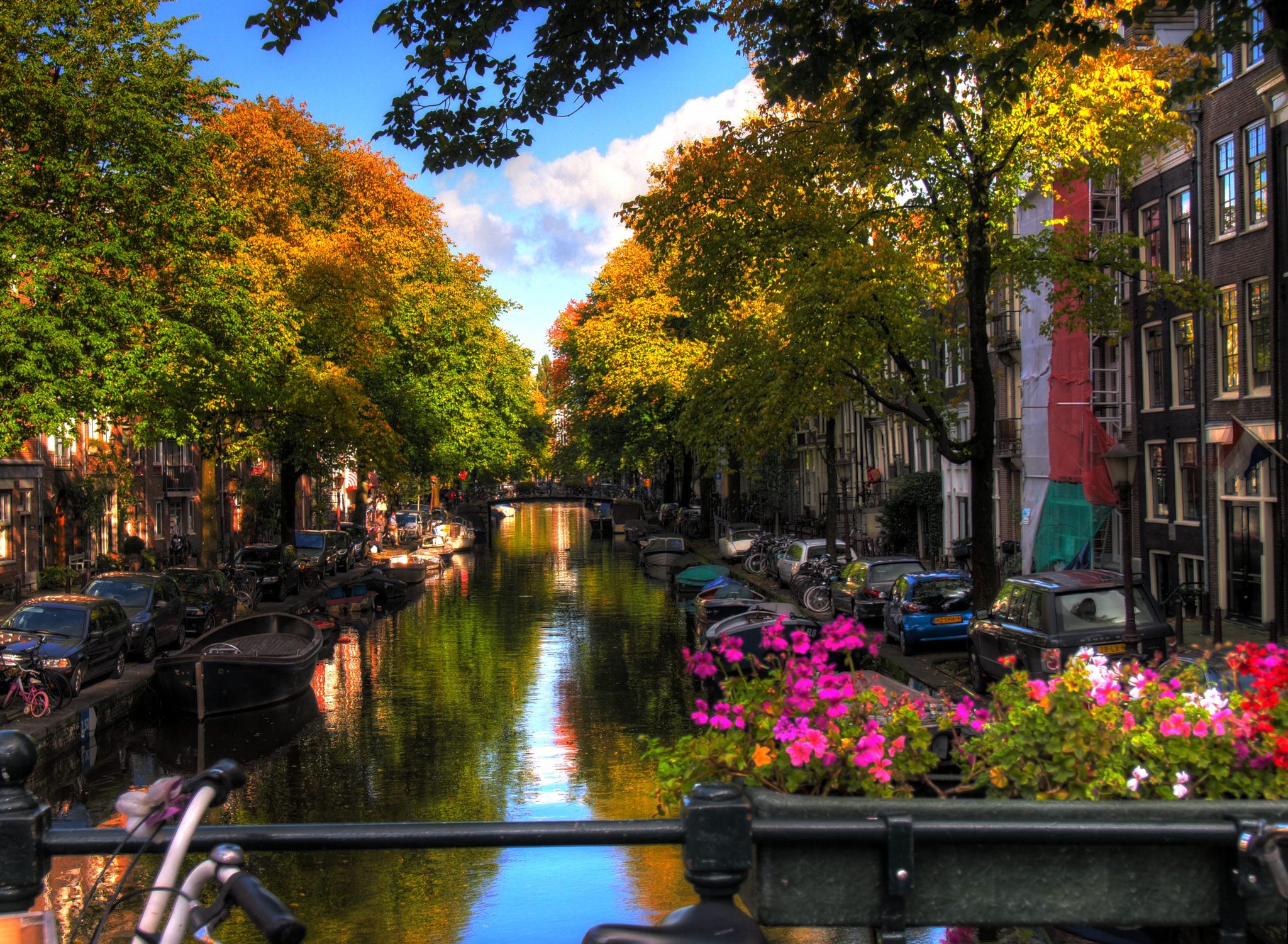 Amsterdam canal with traditional canal houses and trees in autumn