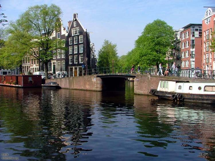 Amsterdam canal in the Jordaan area with houseboats and historic canal houses along Prinsengracht