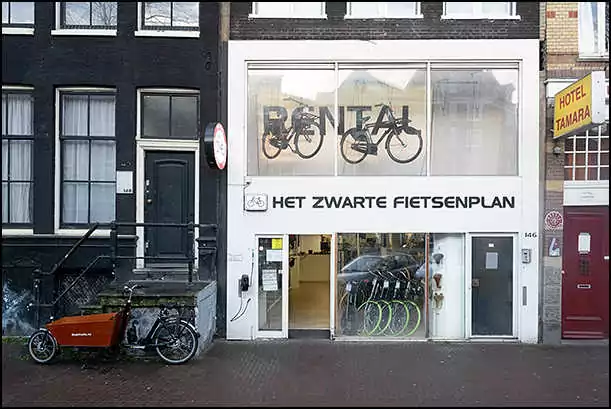 black bikes rental shop storefront amsterdam city center