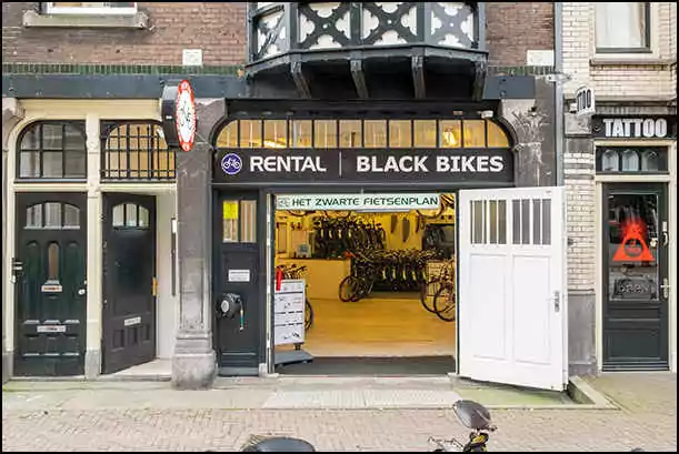 black bikes storefront amsterdam red light district