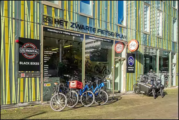 black bikes storefront amsterdam south zuidas