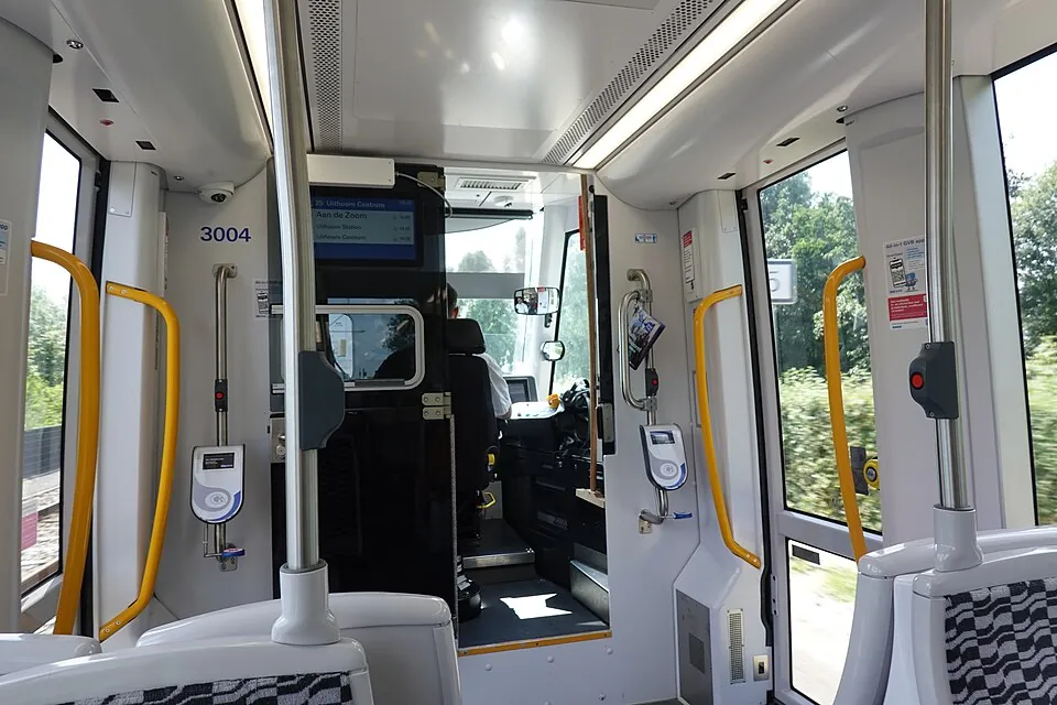 Interior of a GVB 15G tram with card readers next to the doors and the driver's cabin ahead
